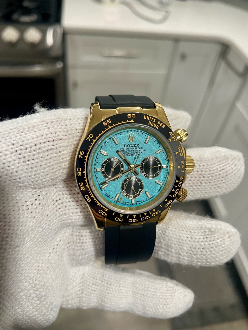 Rolex Gold Automatic Chronograph Watch with Turquoise Dial and Black Strap